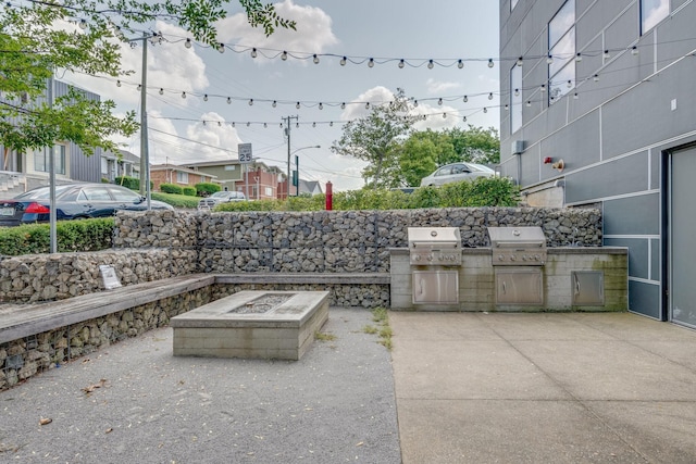 1900 12th Ave S Unit 404, Nashville, TN 37203 - view of patio with a grill, a fire pit, and exterior kitchen