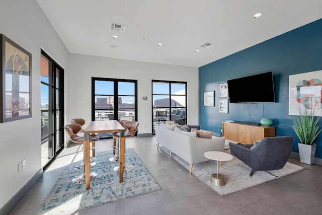 1900 12th Ave S Unit 404, Nashville, TN 37203 - living area with visible vents, baseboards, and recessed lighting