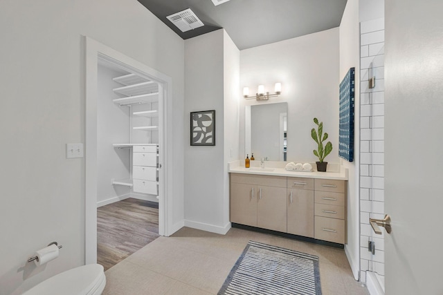 1900 12th Ave S Unit 404, Nashville, TN 37203 - bathroom with toilet, visible vents, baseboards, and vanity