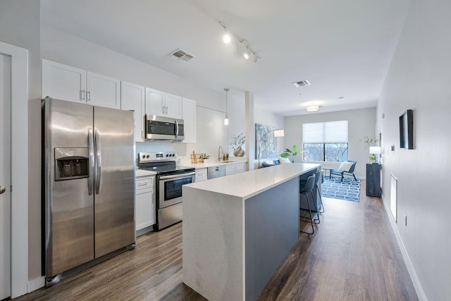 1900 12th Ave S Unit 404, Nashville, TN 37203 - kitchen with white cabinets, visible vents, and appliances with stainless steel finishes