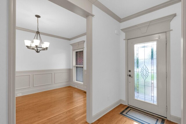 2726 Wynthrope Hall Dr, Murfreesboro, TN 37129 - entrance foyer featuring a chandelier, ornamental molding, healthy amount of natural light, light wood-style floors, and wainscoting