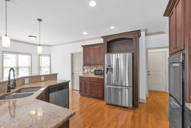 2726 Wynthrope Hall Dr, Murfreesboro, TN 37129 - kitchen with stainless steel appliances, a sink, light wood finished floors, pendant lighting, and ornamental molding