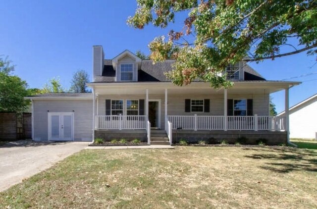 cape cod-style house featuring a front yard, french doors, a chimney, and covered porch