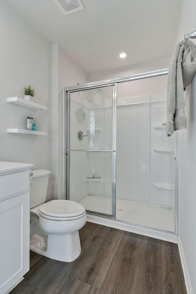3008 Sapgate Ln, Nashville, TN 37207 - full bathroom with visible vents, wood finished floors, toilet, vanity, and a stall shower