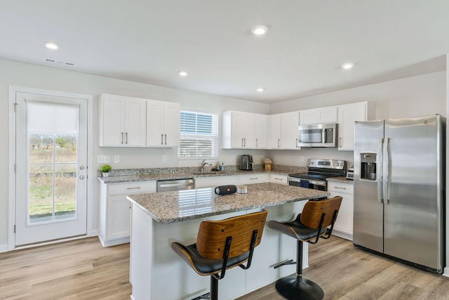 3008 Sapgate Ln, Nashville, TN 37207 - kitchen featuring white cabinetry, appliances with stainless steel finishes, a healthy amount of sunlight, and light wood-type flooring