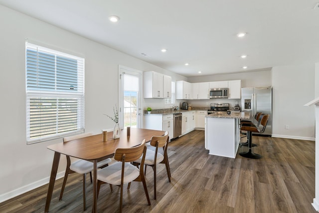 3008 Sapgate Ln, Nashville, TN 37207 - kitchen featuring white cabinets, baseboards, stainless steel appliances, dark wood finished floors, and a center island
