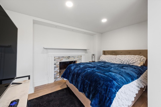 276 E Porters Bluff Rd E, Clarksville, TN 37040 - bedroom featuring baseboards, a fireplace, wood finished floors, and recessed lighting