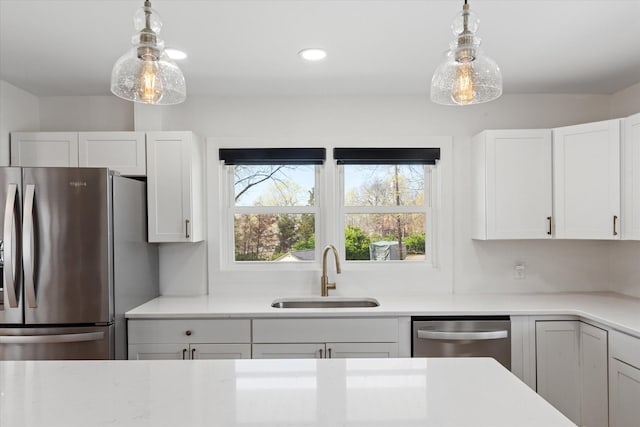 276 E Porters Bluff Rd E, Clarksville, TN 37040 - kitchen featuring white cabinets, a sink, light countertops, and appliances with stainless steel finishes