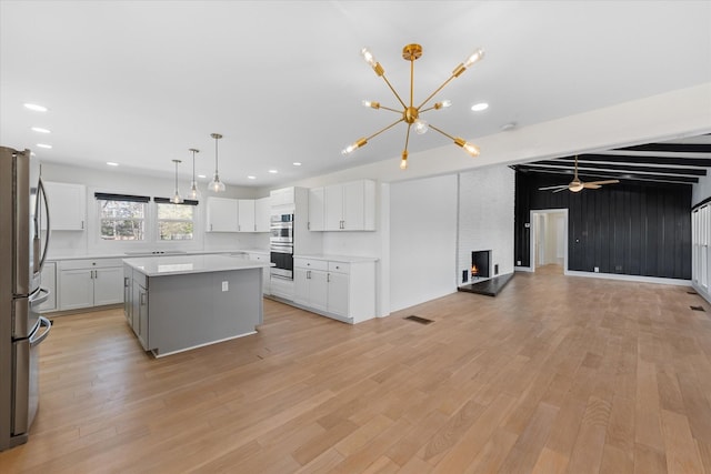 276 E Porters Bluff Rd E, Clarksville, TN 37040 - kitchen featuring open floor plan, light wood-style flooring, a center island, and appliances with stainless steel finishes