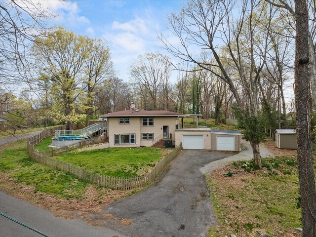 276 E Porters Bluff Rd E, Clarksville, TN 37040 - view of front facade featuring a chimney, an outbuilding, fence, and a garage