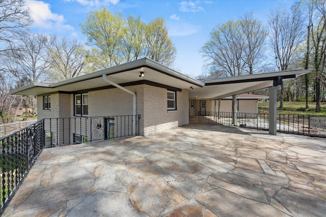 276 E Porters Bluff Rd E, Clarksville, TN 37040 - rear view of property with brick siding, an attached carport, concrete driveway, and fence