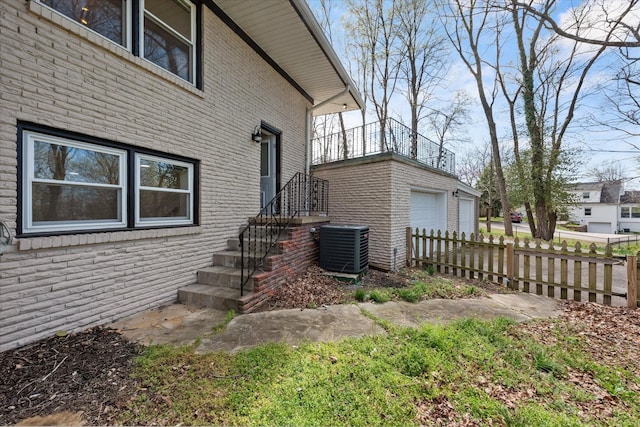 276 E Porters Bluff Rd E, Clarksville, TN 37040 - view of home's exterior featuring brick siding, an outbuilding, central AC unit, and fence