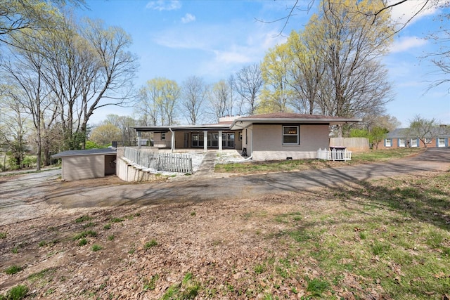 276 E Porters Bluff Rd E, Clarksville, TN 37040 - rear view of house with fence, a storage shed, brick siding, an outdoor structure, and a porch
