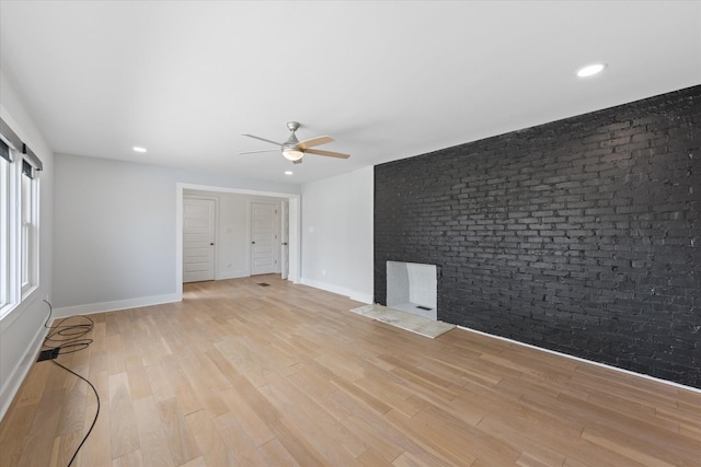 276 E Porters Bluff Rd E, Clarksville, TN 37040 - unfurnished living room featuring light wood-style flooring, recessed lighting, baseboards, brick wall, and a ceiling fan