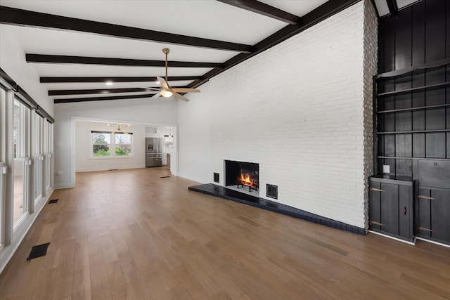 276 E Porters Bluff Rd E, Clarksville, TN 37040 - unfurnished living room with a fireplace, visible vents, and wood finished floors