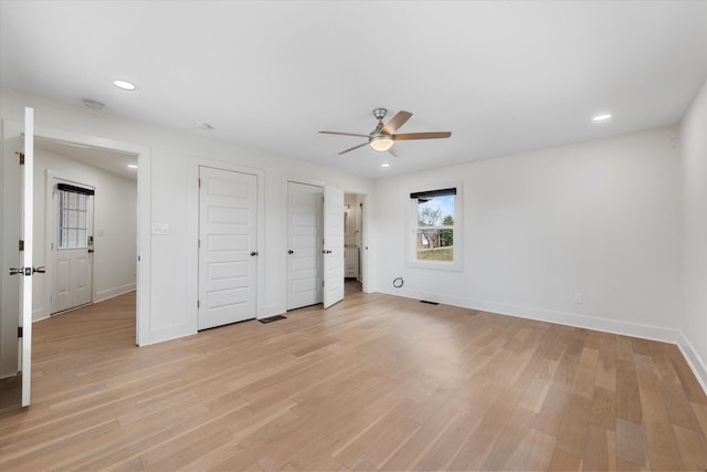 276 E Porters Bluff Rd E, Clarksville, TN 37040 - unfurnished bedroom featuring baseboards, multiple closets, light wood-style floors, and recessed lighting