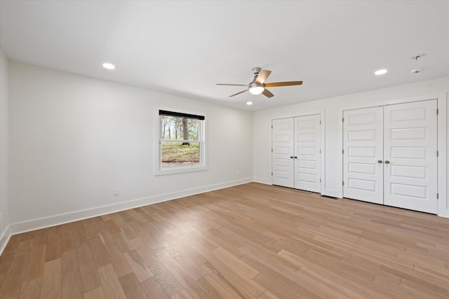 276 E Porters Bluff Rd E, Clarksville, TN 37040 - unfurnished bedroom with two closets, recessed lighting, baseboards, light wood finished floors, and ceiling fan