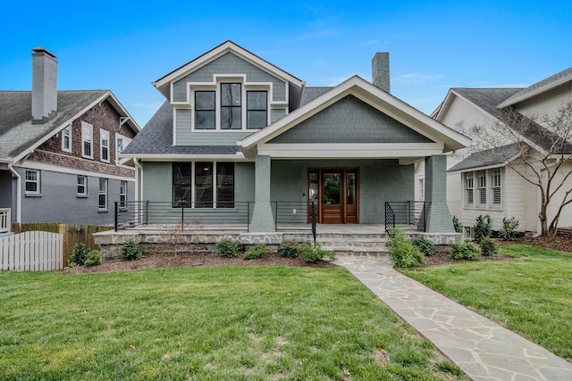 1405 Ashwood Ave, Nashville, TN 37212 - view of front facade featuring brick siding, a front yard, a porch, and fence