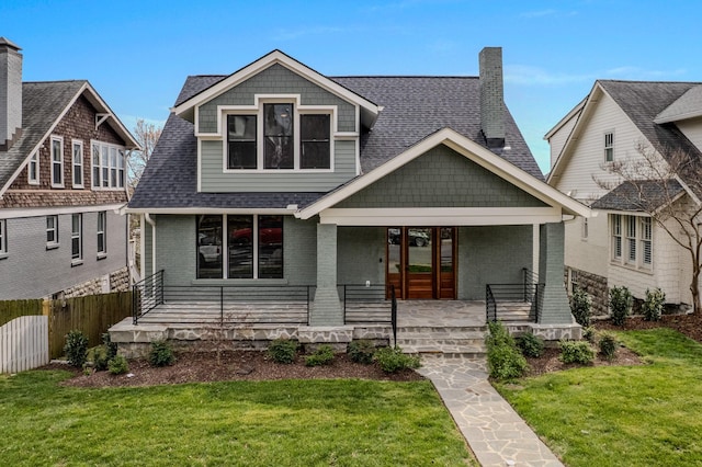 1405 Ashwood Ave, Nashville, TN 37212 - view of front of house with a shingled roof, covered porch, fence, brick siding, and a front lawn