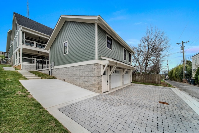 1405 Ashwood Ave, Nashville, TN 37212 - view of home's exterior featuring ceiling fan, an attached garage, fence, a balcony, and decorative driveway