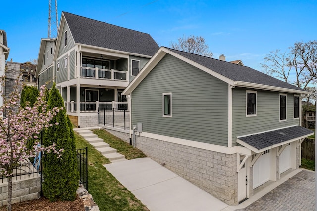 1405 Ashwood Ave, Nashville, TN 37212 - view of home's exterior featuring a balcony, a chimney, driveway, an attached garage, and a shingled roof