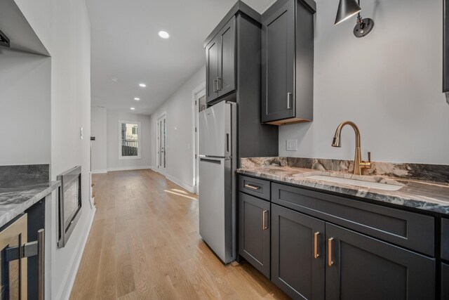 1405 Ashwood Ave, Nashville, TN 37212 - kitchen featuring freestanding refrigerator, recessed lighting, stone countertops, a sink, and light wood finished floors