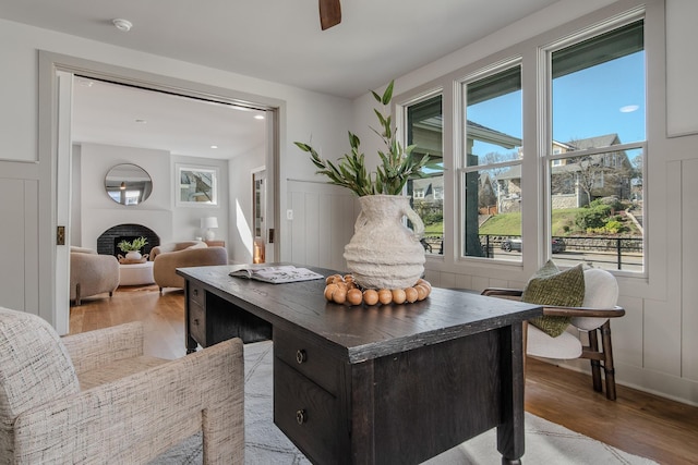 1405 Ashwood Ave, Nashville, TN 37212 - home office featuring light wood-style flooring, a decorative wall, a fireplace, and a wealth of natural light