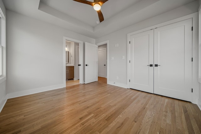 1405 Ashwood Ave, Nashville, TN 37212 - unfurnished bedroom with light wood-type flooring, a closet, ensuite bath, a raised ceiling, and baseboards