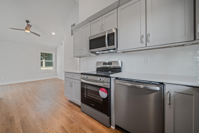 1405 Ashwood Ave, Nashville, TN 37212 - kitchen with tasteful backsplash, light countertops, appliances with stainless steel finishes, and lofted ceiling