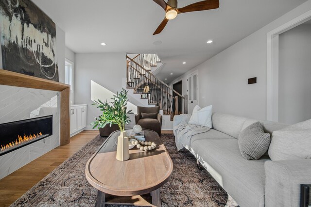 1405 Ashwood Ave, Nashville, TN 37212 - living room featuring a ceiling fan, a fireplace, recessed lighting, light wood finished floors, and stairs