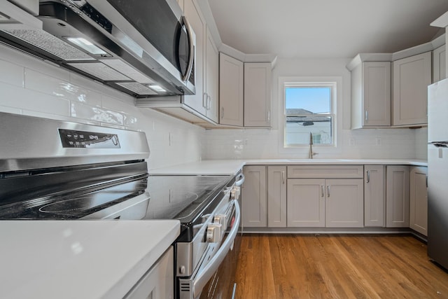 1405 Ashwood Ave, Nashville, TN 37212 - kitchen with light wood-style flooring, light countertops, a sink, and appliances with stainless steel finishes