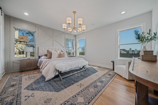 1405 Ashwood Ave, Nashville, TN 37212 - bedroom featuring a decorative wall, wood finished floors, a notable chandelier, and recessed lighting