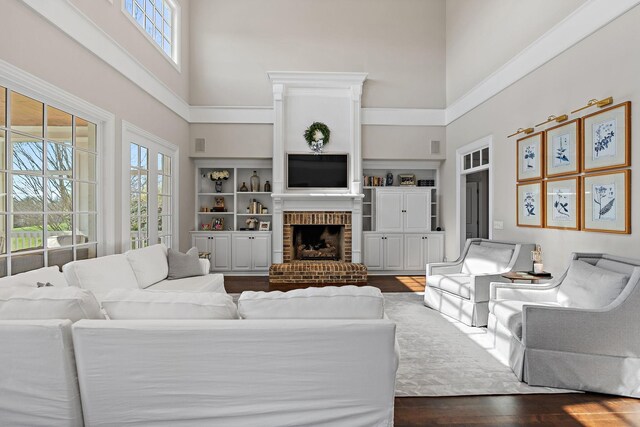4 Colonel Winstead Dr, Brentwood, TN 37027 - living room featuring a fireplace, a high ceiling, dark wood-style floors, and visible vents