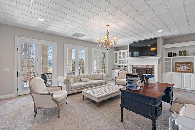 4 Colonel Winstead Dr, Brentwood, TN 37027 - carpeted living room with a chandelier, french doors, a fireplace, baseboards, and recessed lighting