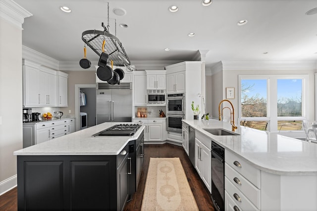 4 Colonel Winstead Dr, Brentwood, TN 37027 - kitchen with crown molding, a sink, built in appliances, white cabinetry, and a kitchen island