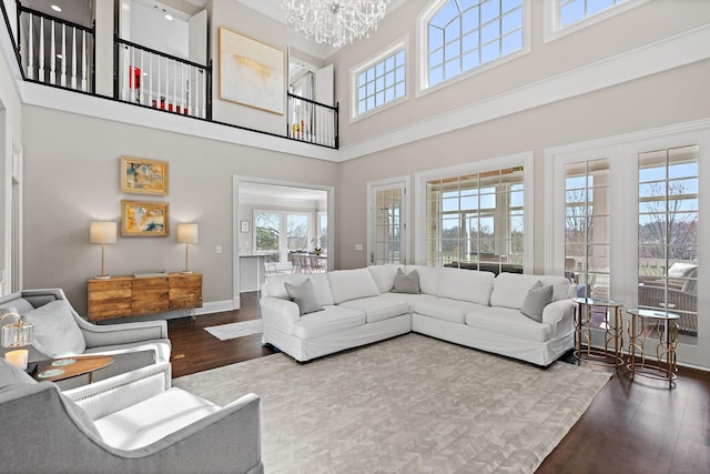 4 Colonel Winstead Dr, Brentwood, TN 37027 - living area with dark wood-type flooring, a chandelier, a towering ceiling, and baseboards
