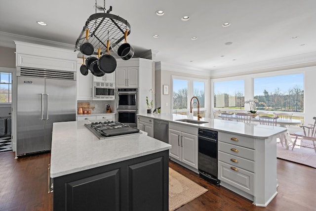 4 Colonel Winstead Dr, Brentwood, TN 37027 - kitchen with a sink, built in appliances, a kitchen island, dark wood-type flooring, and ornamental molding