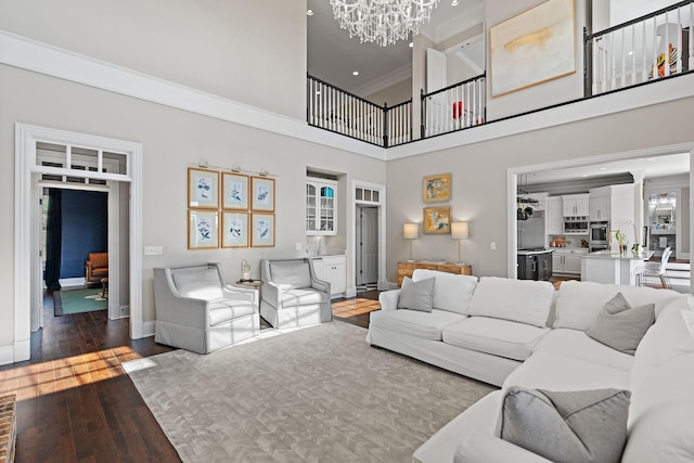 4 Colonel Winstead Dr, Brentwood, TN 37027 - living room with dark wood-style floors, a towering ceiling, baseboards, an inviting chandelier, and ornamental molding