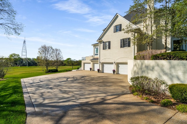 4 Colonel Winstead Dr, Brentwood, TN 37027 - view of side of property featuring an attached garage, stucco siding, and concrete driveway