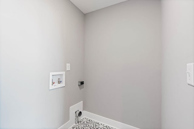 clothes washing area featuring baseboards, laundry area, and hookup for a washing machine