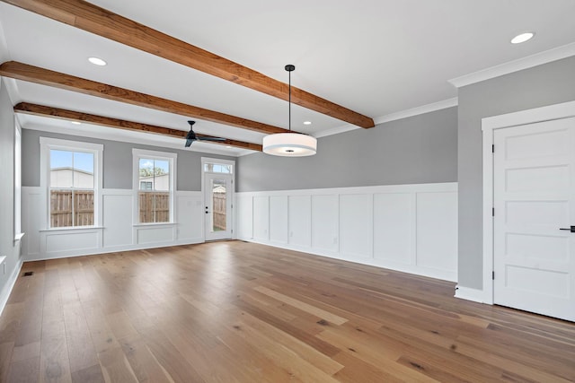 interior space with wood finished floors, recessed lighting, and beam ceiling