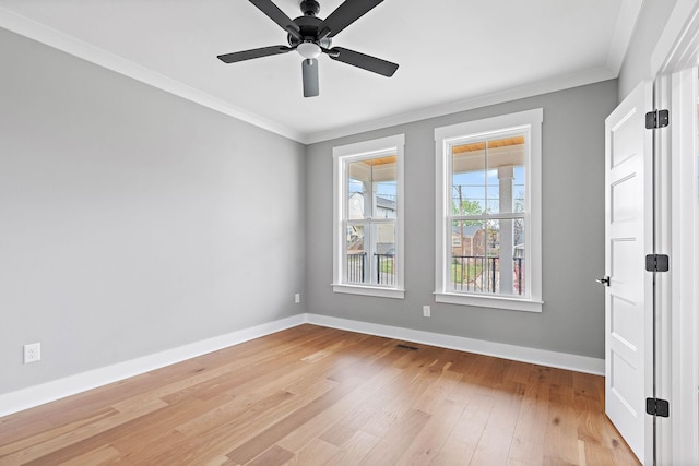 empty room featuring baseboards, a ceiling fan, wood finished floors, and crown molding