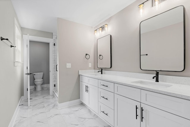 full bath with baseboards, marble finish floor, a sink, and double vanity