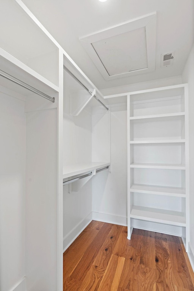 spacious closet with wood finished floors