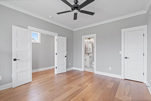 unfurnished bedroom with crown molding, light wood finished floors, ensuite bathroom, baseboards, and ceiling fan