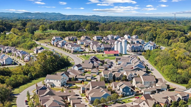 birds eye view of property with a residential view and a wooded view
