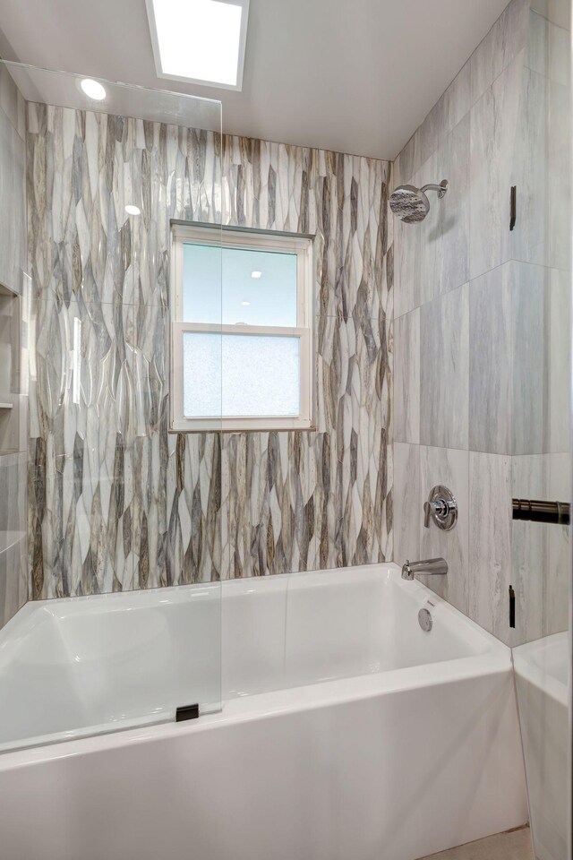 bathroom with tile walls and tub / shower combination