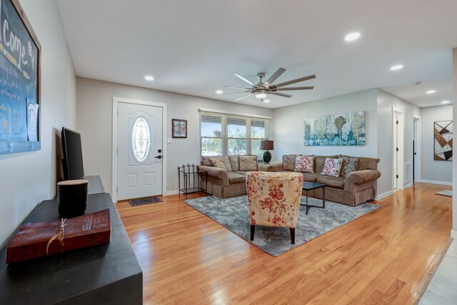 living area with a ceiling fan, baseboards, recessed lighting, and light wood-style floors
