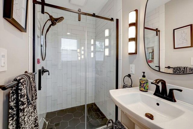 bathroom featuring a sink and a stall shower