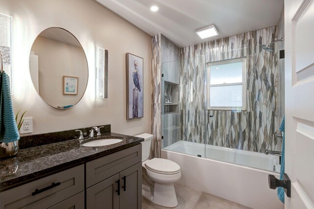bathroom with recessed lighting, toilet, vanity, and shower / tub combination